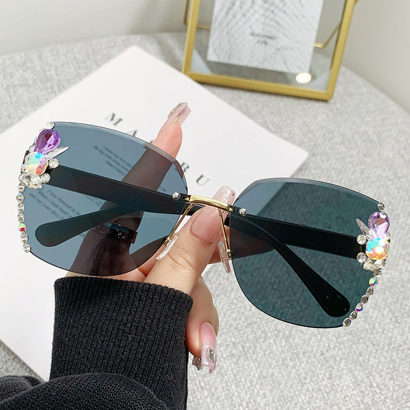 Women's fashion glasses 2023跨境欧美无框切边镶钻太阳镜女防紫外线墨镜海洋片遮阳眼镜